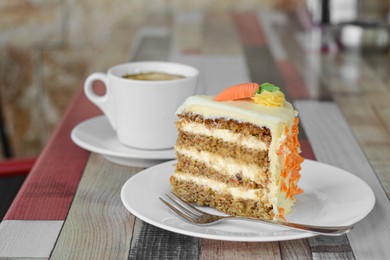 Delicious cake and cup of hot coffee on wooden table