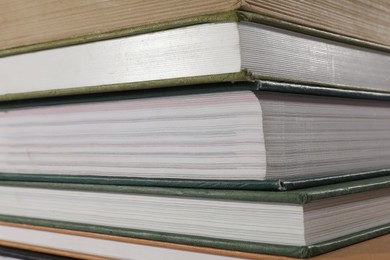 Photo of Stack of many different hardcover books as background, closeup