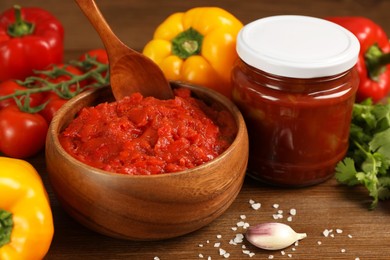 Photo of Delicious lecho and fresh ingredients on wooden table, closeup