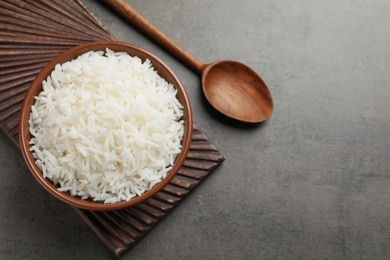 Photo of Bowl of cooked white rice served on table, flat lay. Space for text