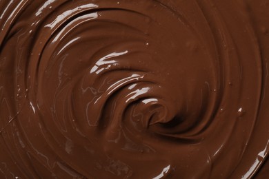 Tasty milk chocolate paste as background, top view