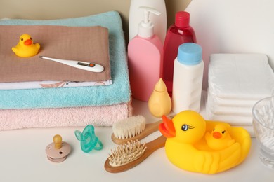 Photo of Towels, toys and baby accessories on white table