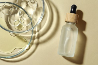 Petri dishes and cosmetic products on beige background, flat lay