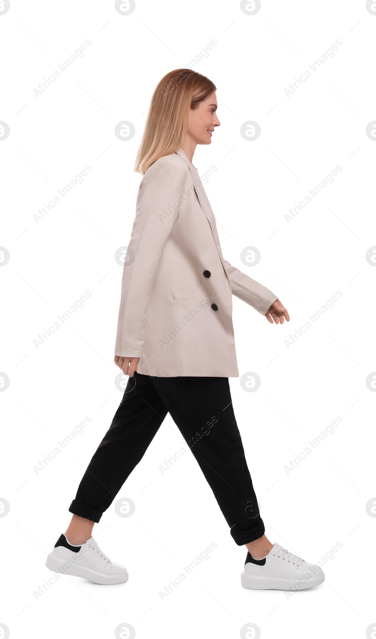 Photo of Beautiful happy businesswoman walking on white background