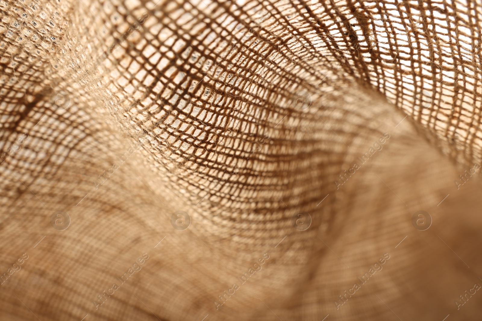 Photo of Texture of natural burlap fabric as background, closeup