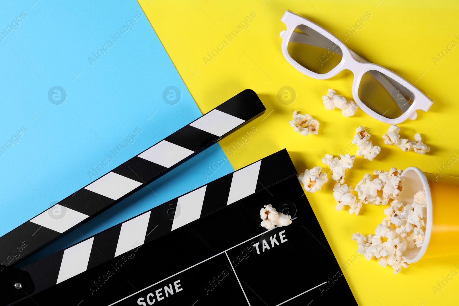 Photo of Clapperboard, popcorn and 3D glasses on color background, flat lay