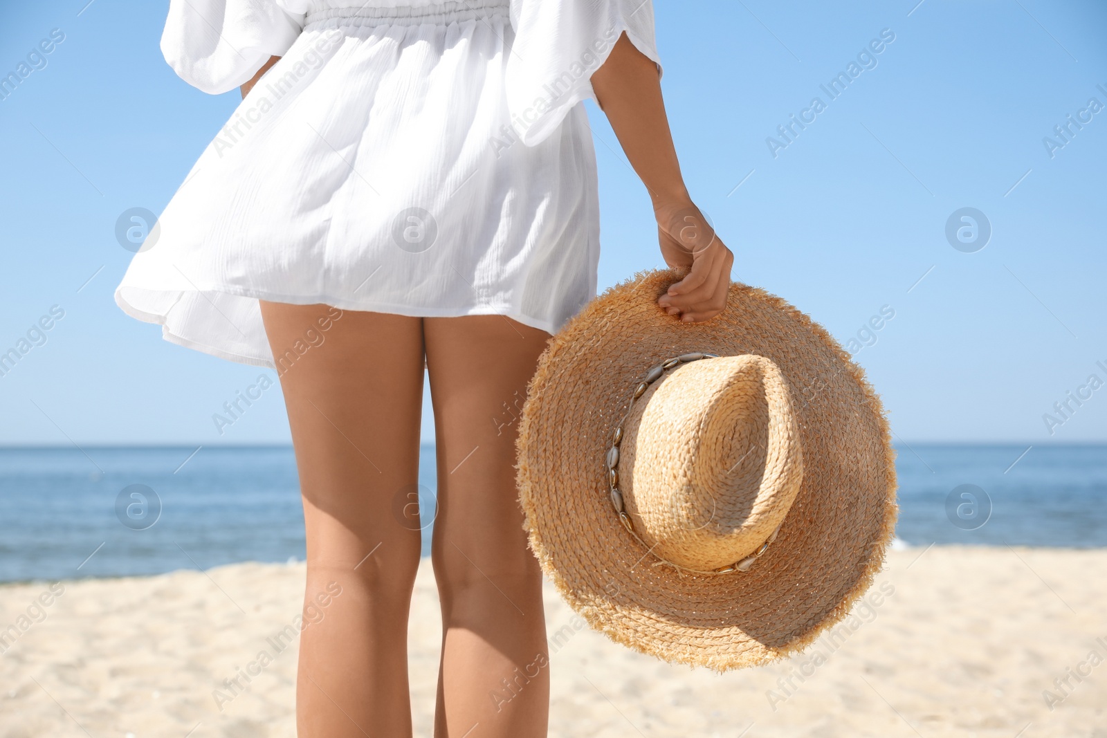 Photo of Young woman with beautiful body on beach, closeup