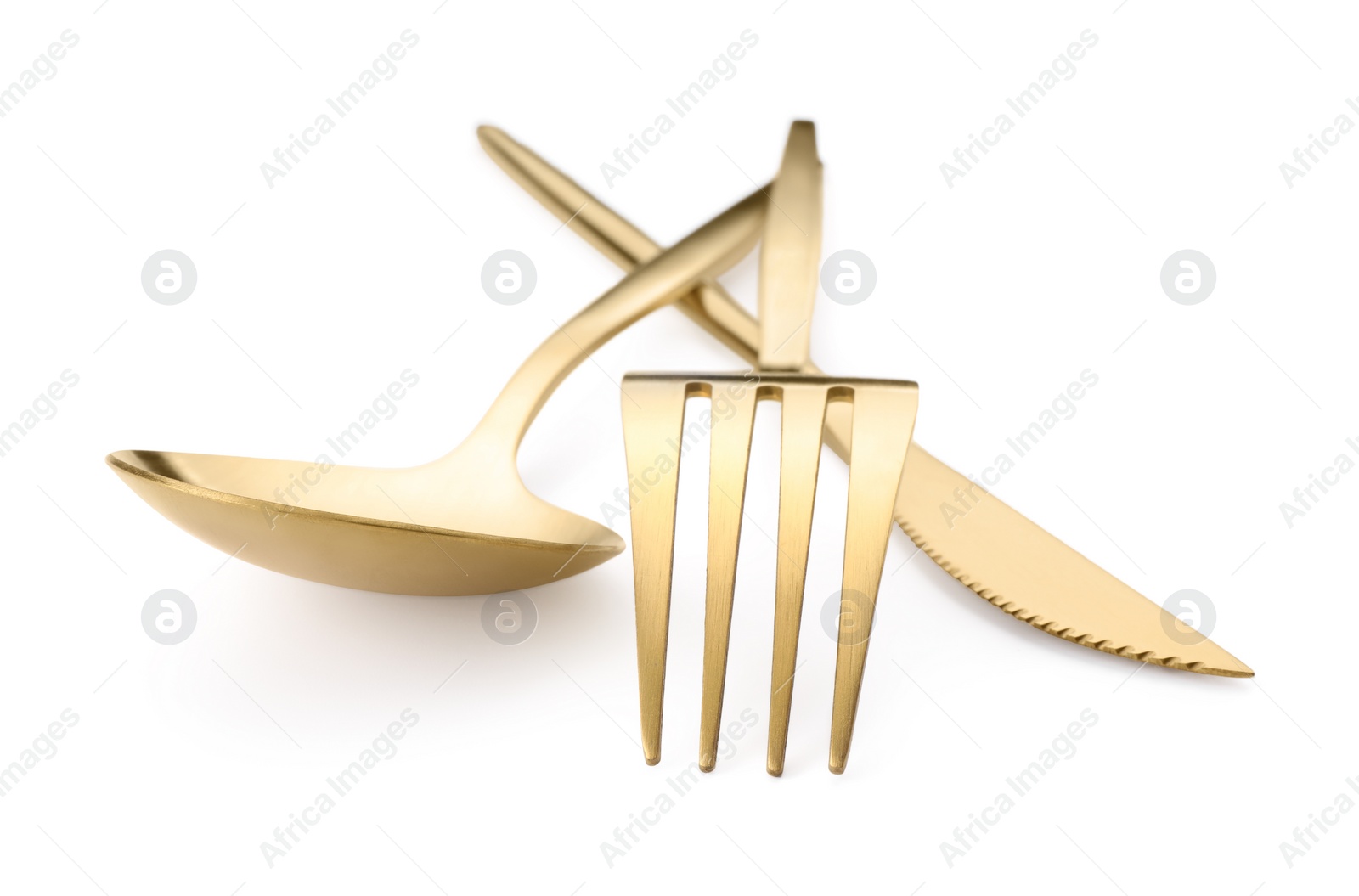 Photo of Shiny golden fork, knife and spoon isolated on white. Luxury cutlery set