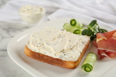 Photo of Delicious sandwich with cream cheese, cucumber and jamon on plate, closeup