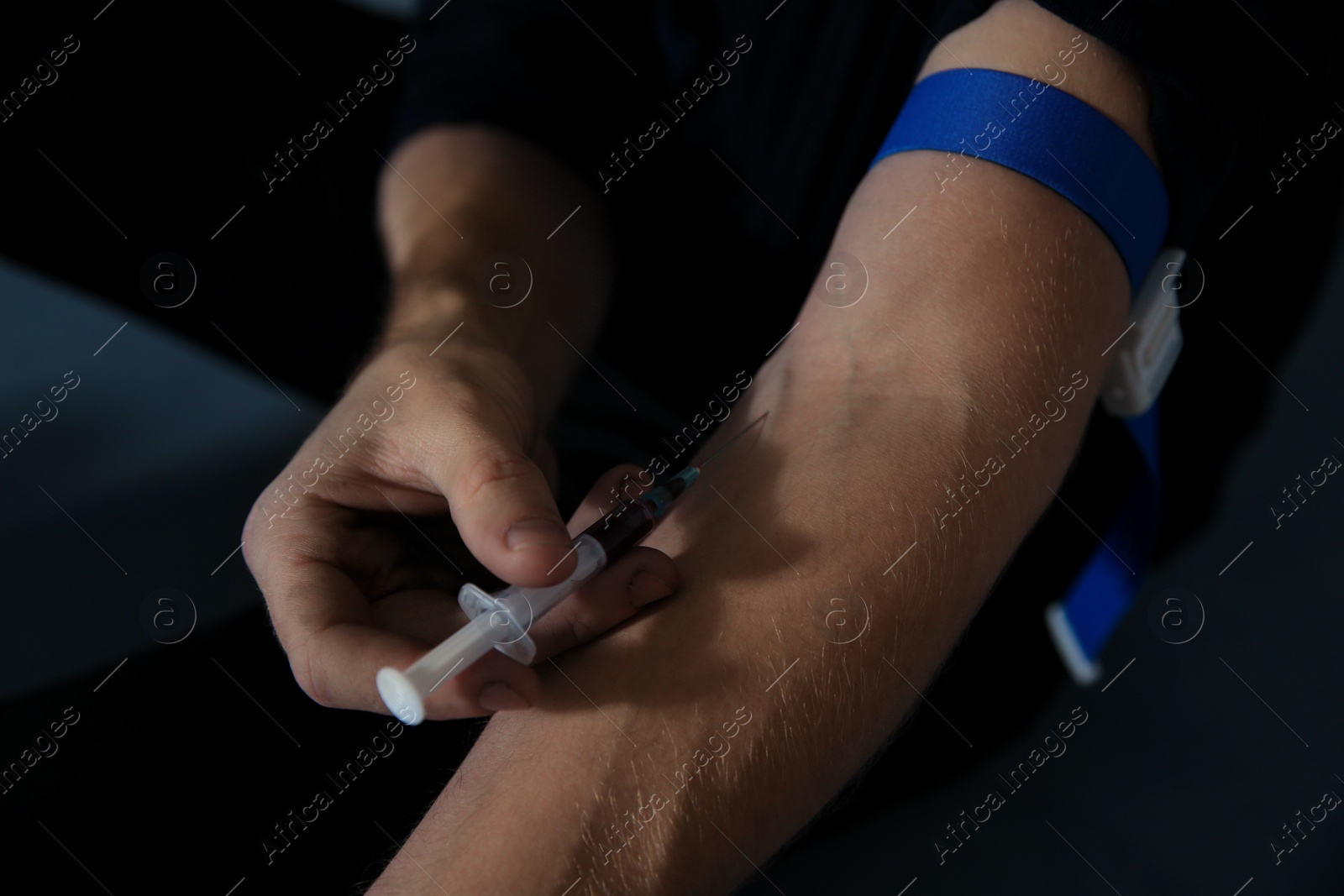 Photo of Male drug addict making injection, closeup view