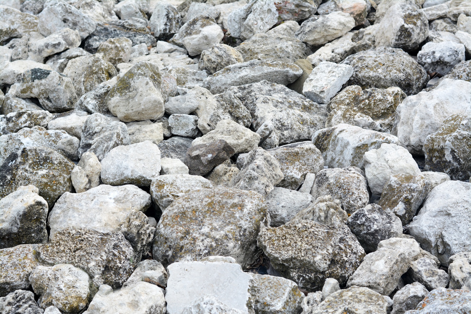 Photo of Pile of grey stones as background, closeup