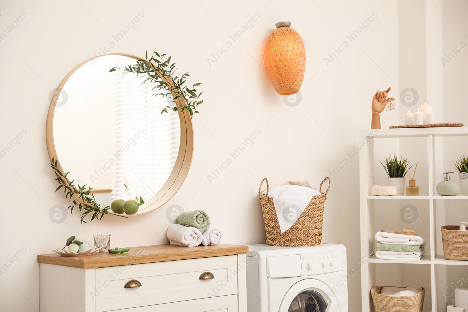 Photo of Round mirror on white wall in modern bathroom