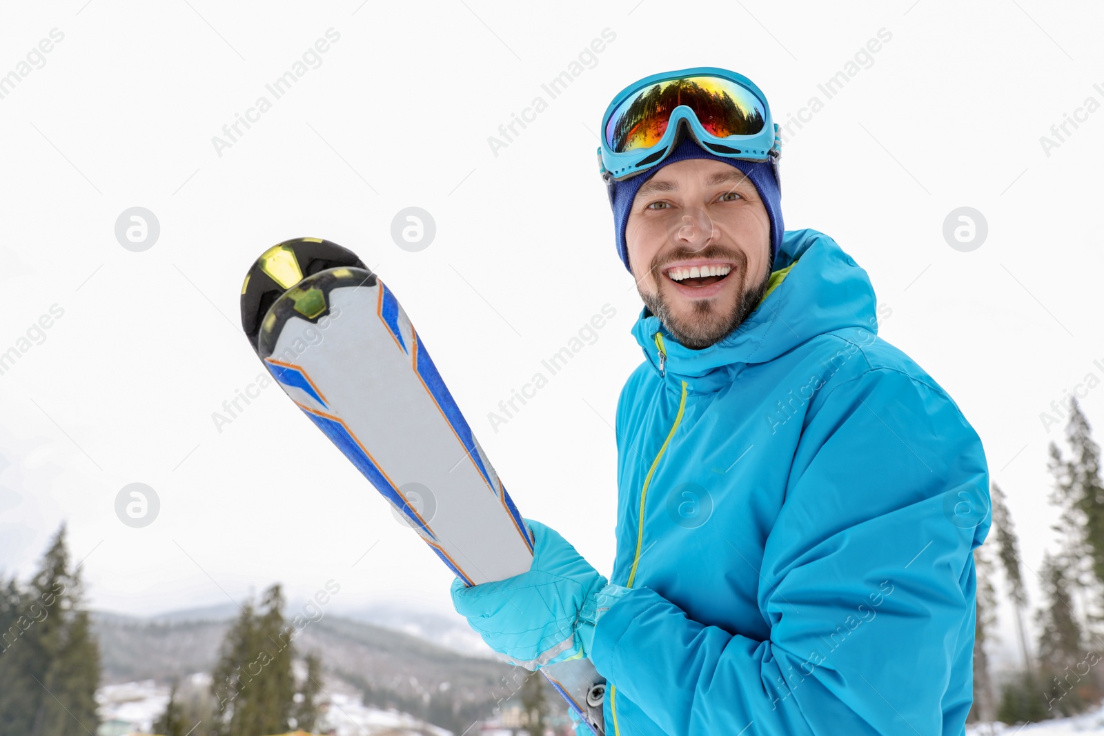 Photo of Male skier on slope at resort. Winter vacation