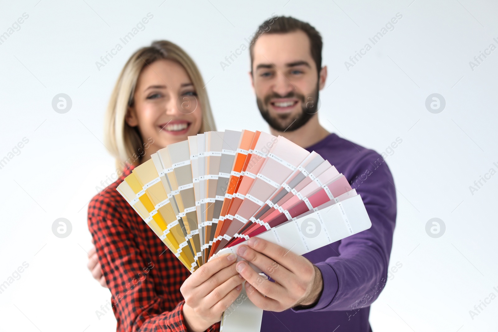 Photo of Young couple with color palette on white background