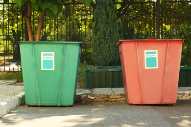 Photo of Recycling bins for different types of garbage outdoors