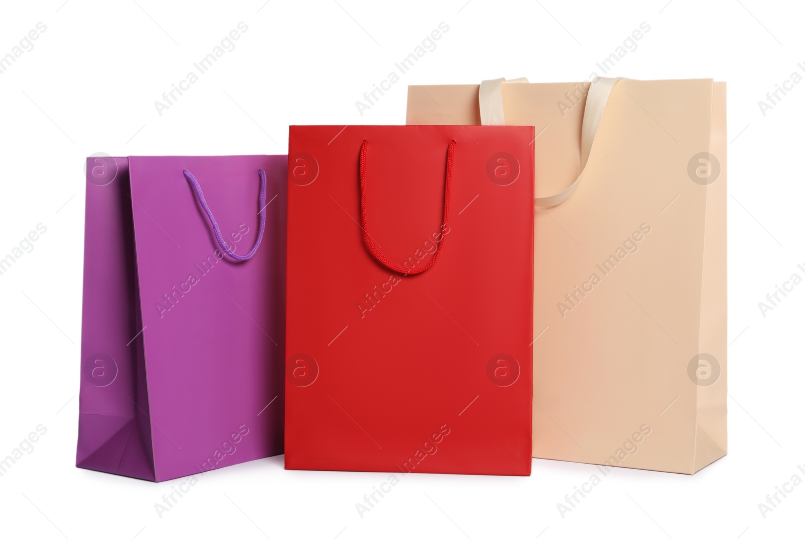 Photo of Colorful paper shopping bags isolated on white