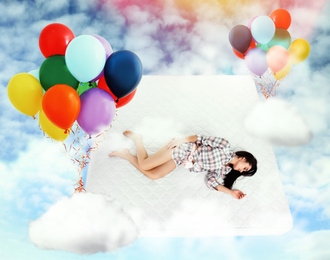 Image of Sweet dreams. Bright cloudy sky with air balloons around sleeping young woman 