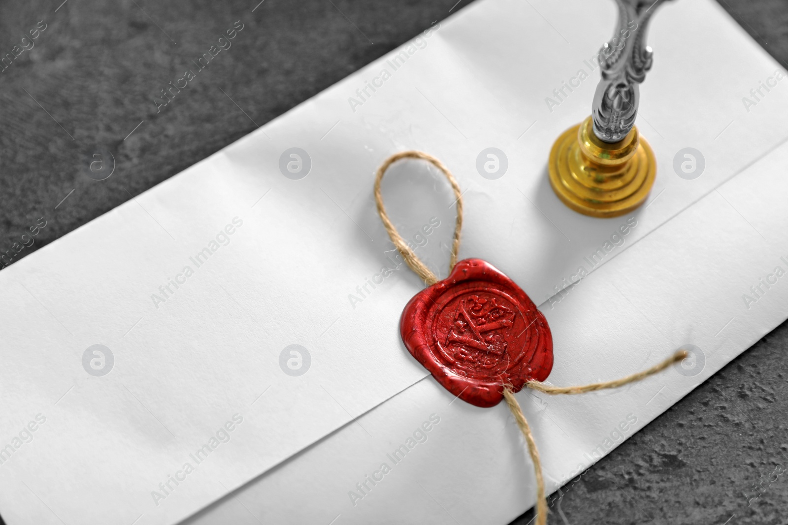 Photo of Vintage notary stamp and sealed document on grey background, closeup