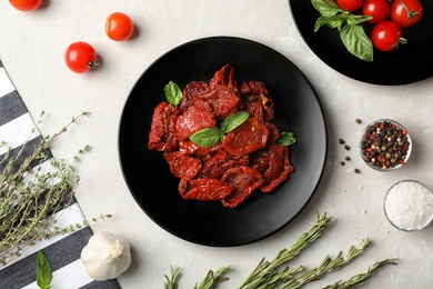 Flat lay composition with dried tomatoes on table