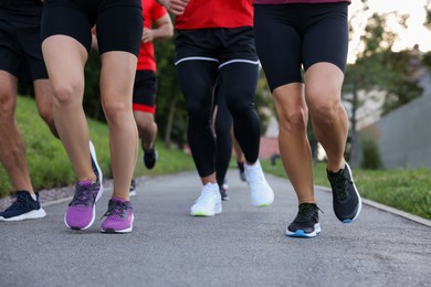 Photo of Group of people running outdoors, closeup view