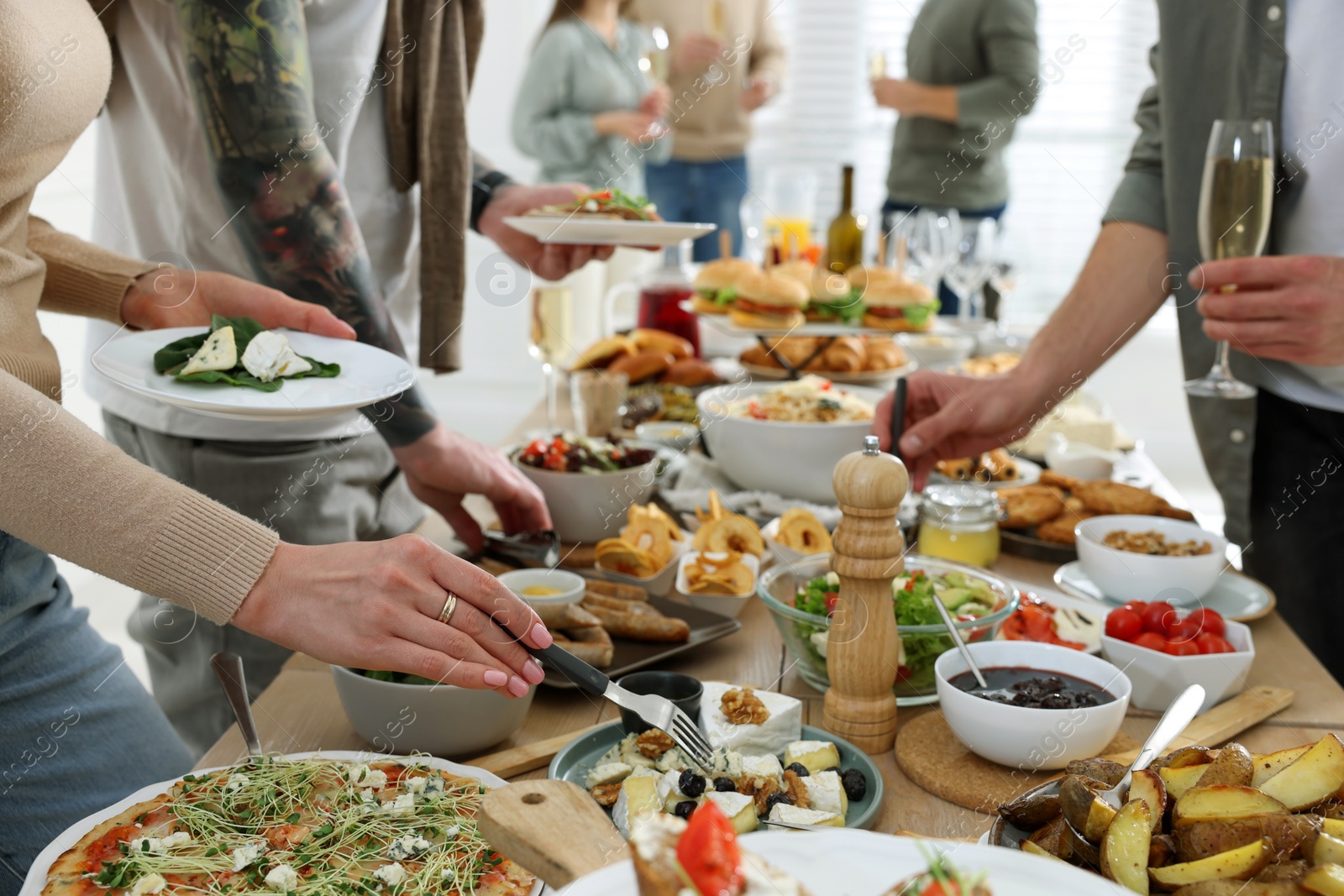 Photo of People near buffet table with food indoors, closeup. Brunch setting