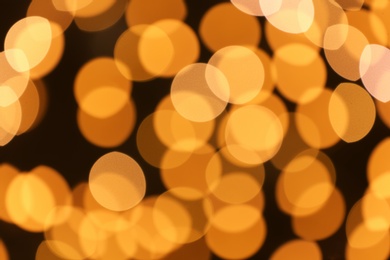 Photo of Beautiful golden lights on dark background. Bokeh effect