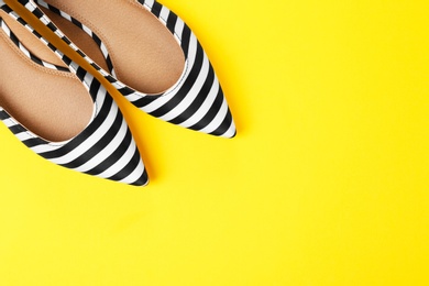 Photo of Pair of female shoes on color background, top view