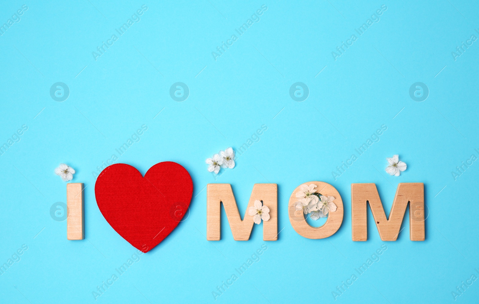 Photo of Phrase "I LOVE MOM" made of letters and red heart on color background. Happy Mother's Day