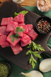 Raw beef meat and different ingredients for cooking delicious goulash on table, flat lay