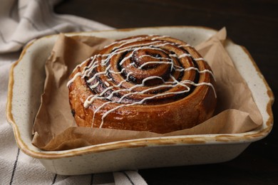 Photo of Delicious roll with topping and poppy seeds on table, closeup. Sweet bun