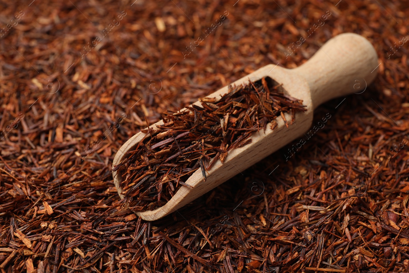 Photo of Rooibos tea and wooden scoop, closeup view