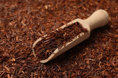 Rooibos tea and wooden scoop, closeup view