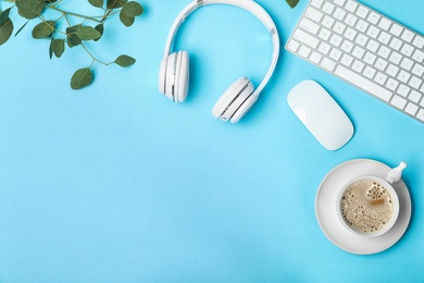 Photo of Flat lay composition with computer keyboard, cup of coffee, headphones and space for text on color background