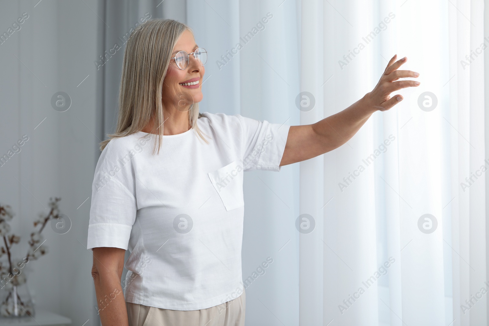 Photo of Portrait of beautiful middle aged woman in eyeglasses indoors