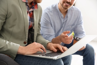 Photo of Business people working on laptop in office, closeup. Professional communication