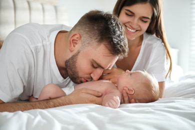 Happy couple with their newborn baby at home