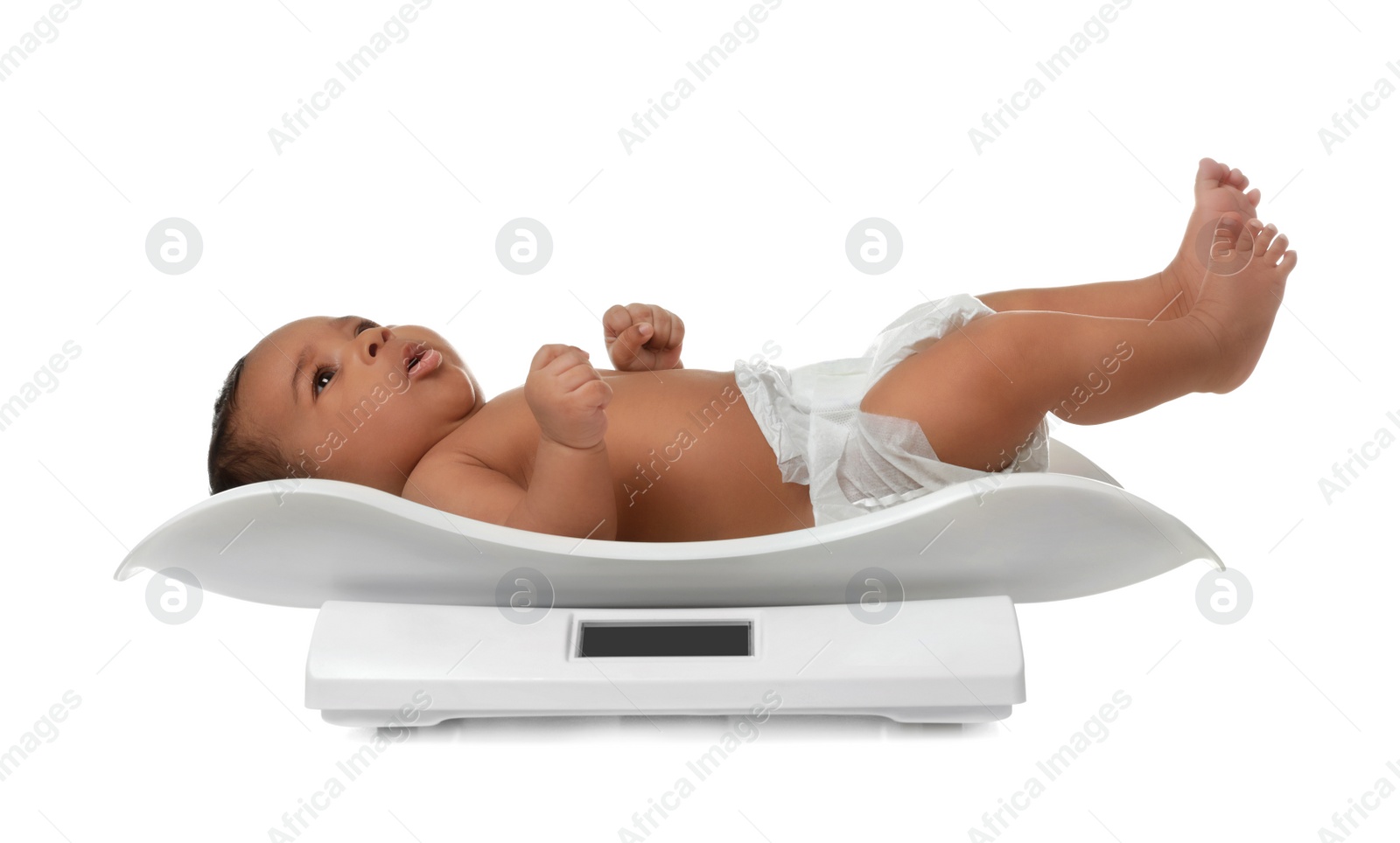 Photo of African-American baby lying on scales against white background