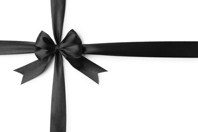 Photo of Black satin ribbon with bow isolated on white, top view