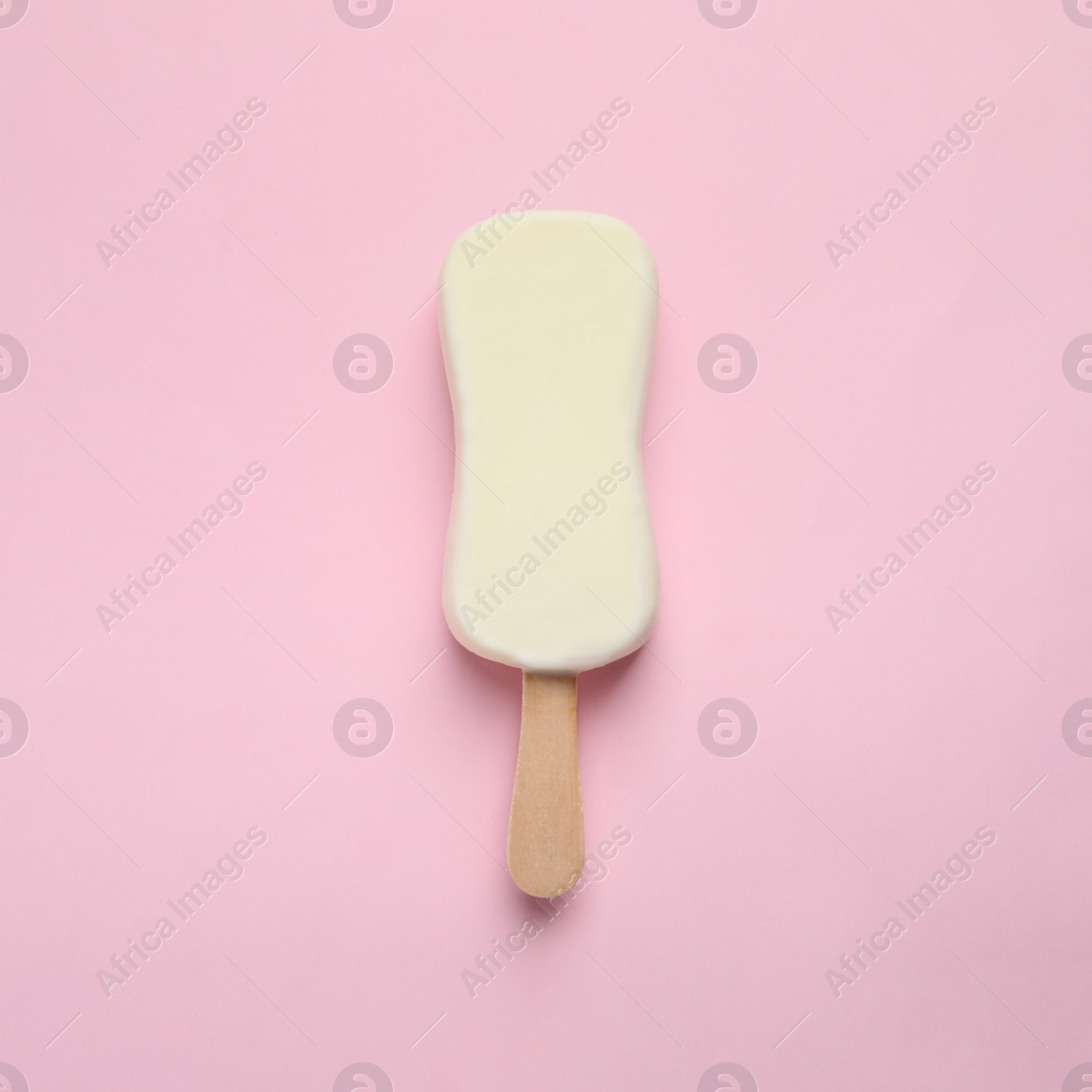Photo of Ice cream with glaze on pink background, top view