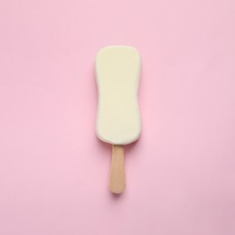 Photo of Ice cream with glaze on pink background, top view