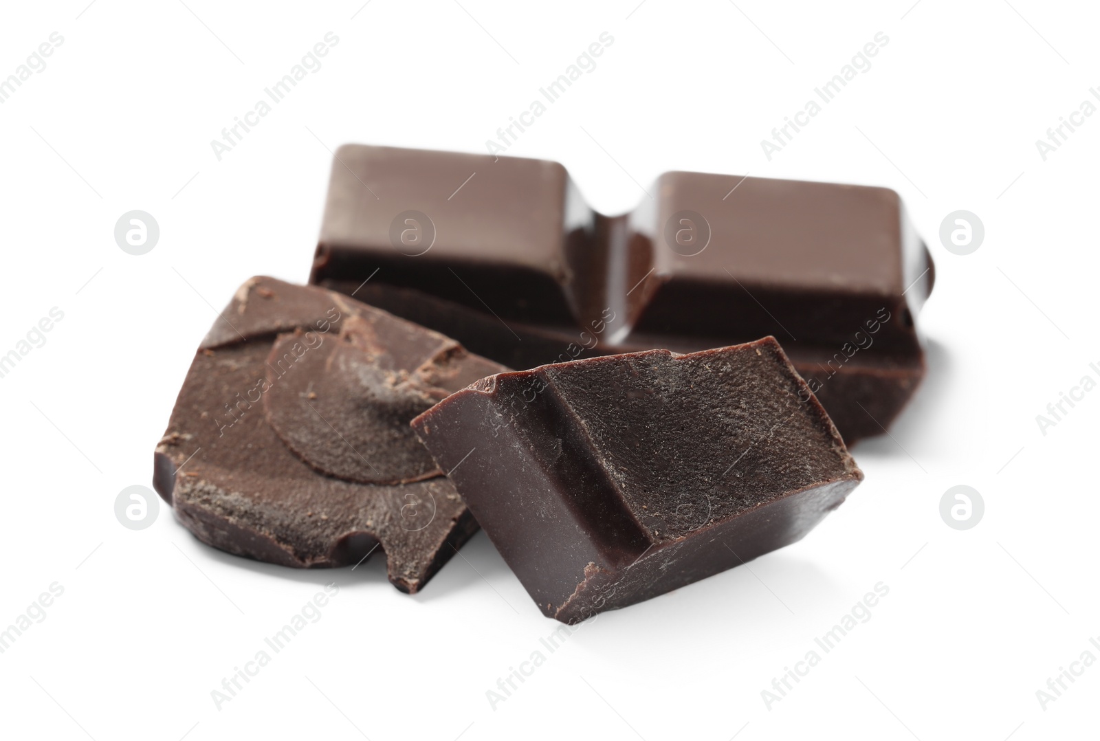 Photo of Pieces of delicious dark chocolate isolated on white