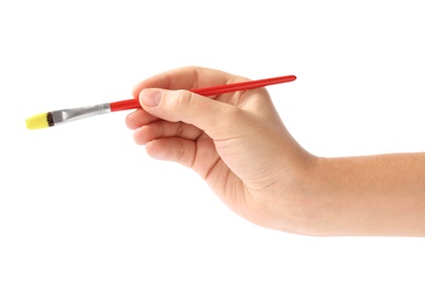 Young woman holding brush with color paint on white background, closeup