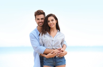 Photo of Happy young couple spending time together on beach