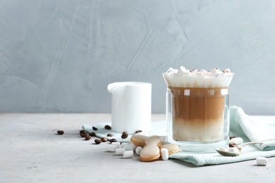 Photo of Composition with glass of delicious coffee drink and different sweets on table. Space for text