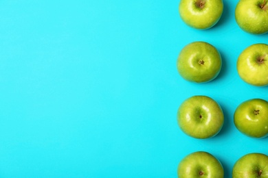 Photo of Many juicy green apples and space for text on color background, top view