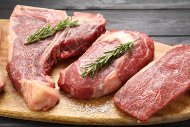 Photo of Pieces of raw beef meat on table, closeup