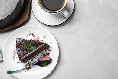 Photo of Tasty chocolate cake on grey table, flat lay. Space for text