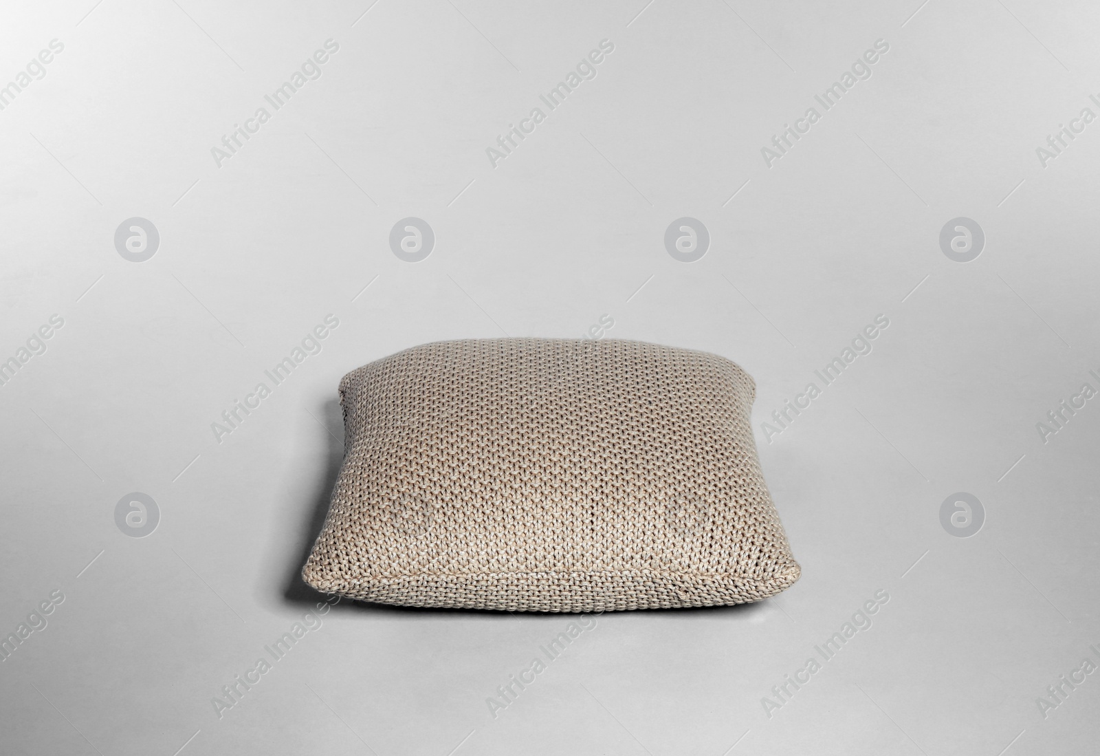 Photo of Single stylish decorative pillow on light background