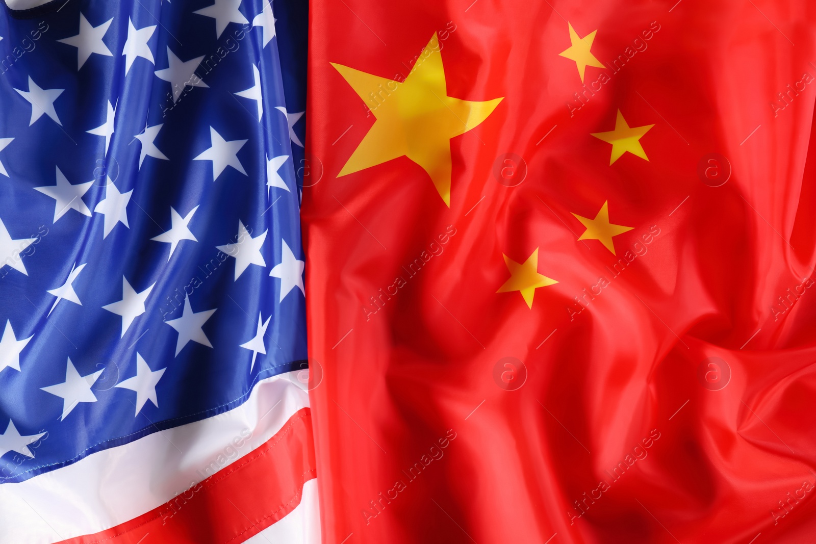 Photo of USA and China flags as background, top view. International relations