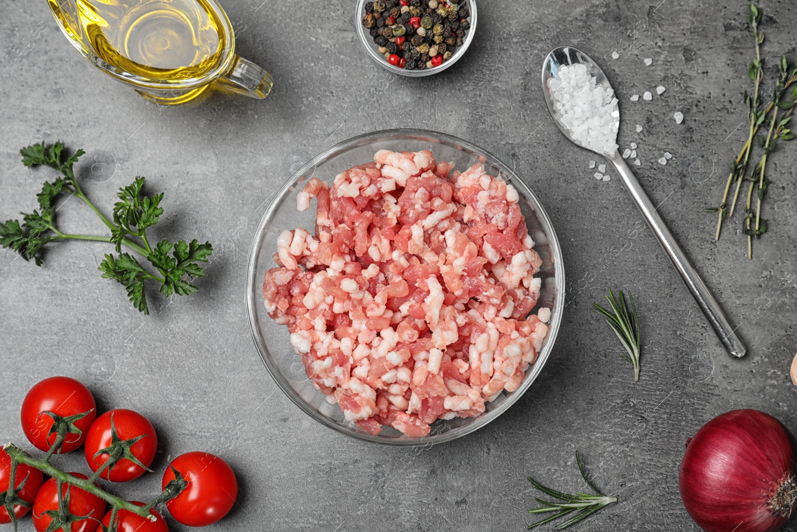 Photo of Flat lay composition with minced meat on grey background